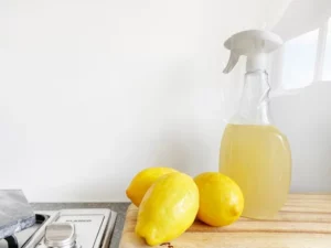 natural cleaning solution with lemons on wood countertop