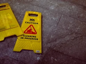 yellow wet floor sign that reads "Caution Cleaning in Progress"