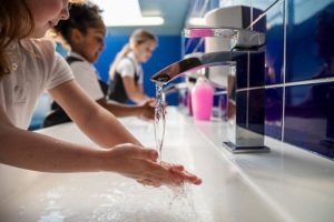 Children Washing Their Hands in a School Bathroom